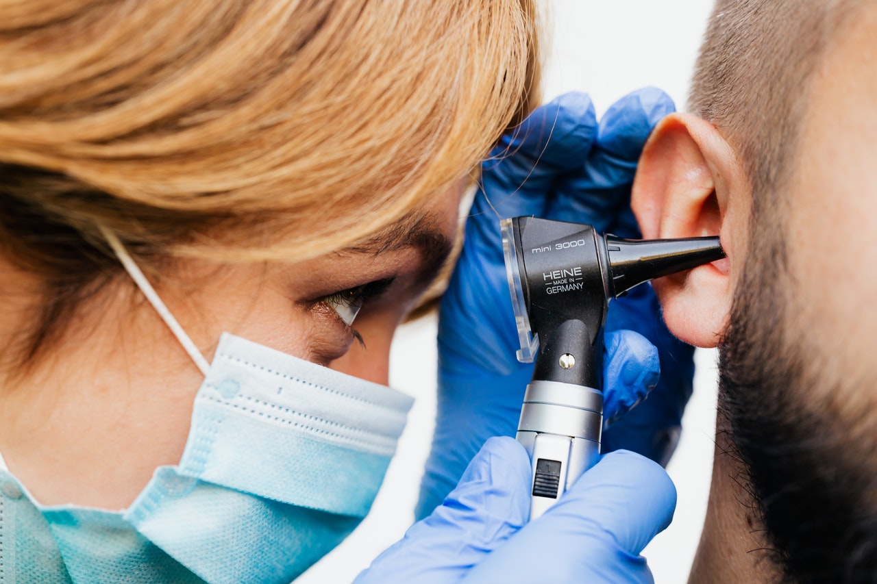 Doctor is examing patients ear