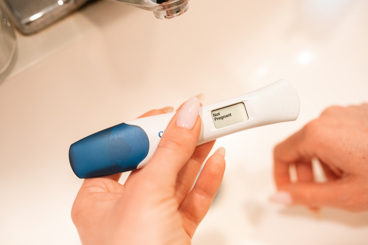Negative pregnancy test in woman's hand