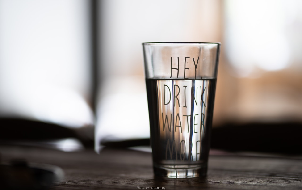 Glass of water standing on table