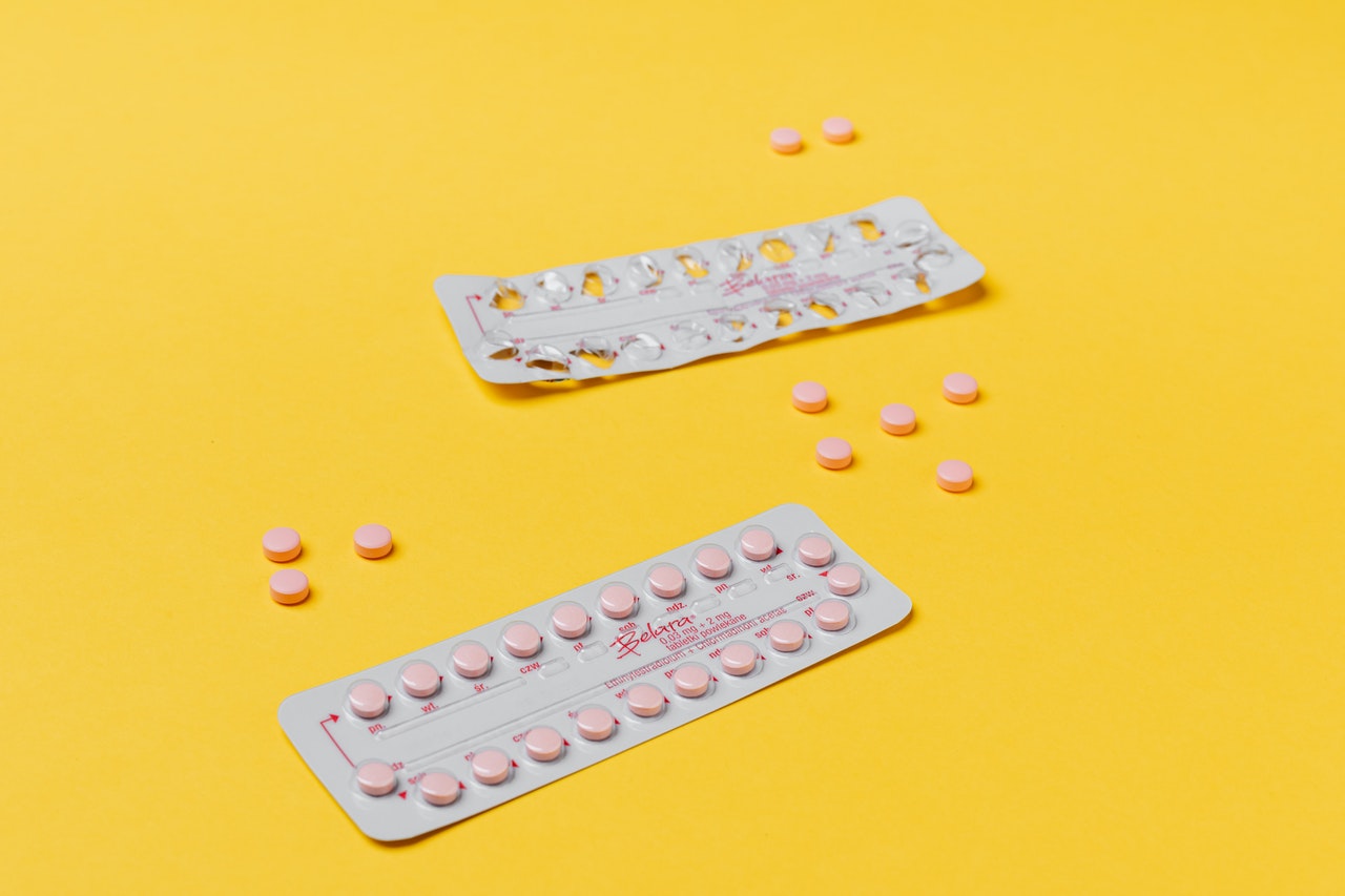 Hormonal birth control on yellow background