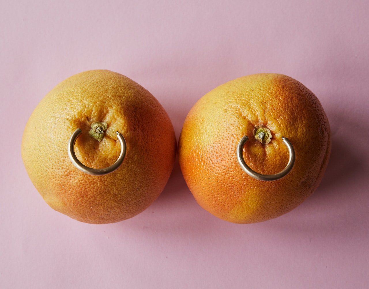 Two oranges with pircing
